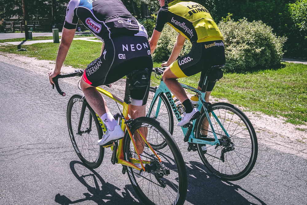 Two cyclists riding side by side