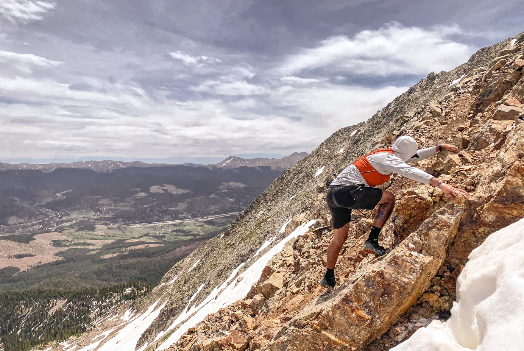 Man bouldering side of a mountain