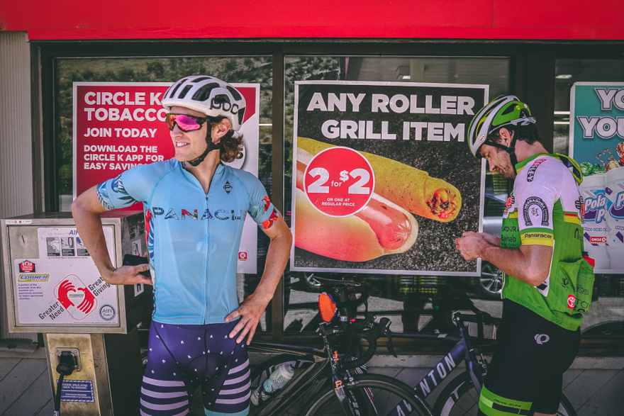 Two cyclists standing in front of a convenience store