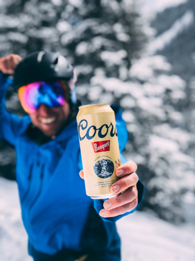 Skier holding a beer can